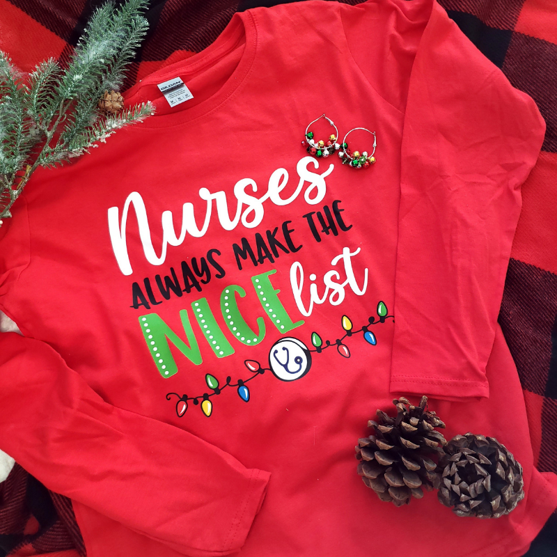 Red tshirt says Nurses Always Make the Nice List with Christmas holiday lights
