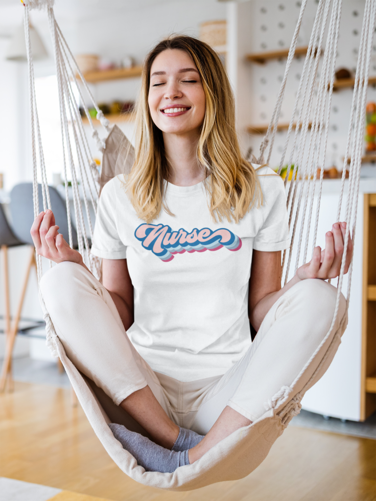 Woman meditating on a hammock wearing a nurse tshirt