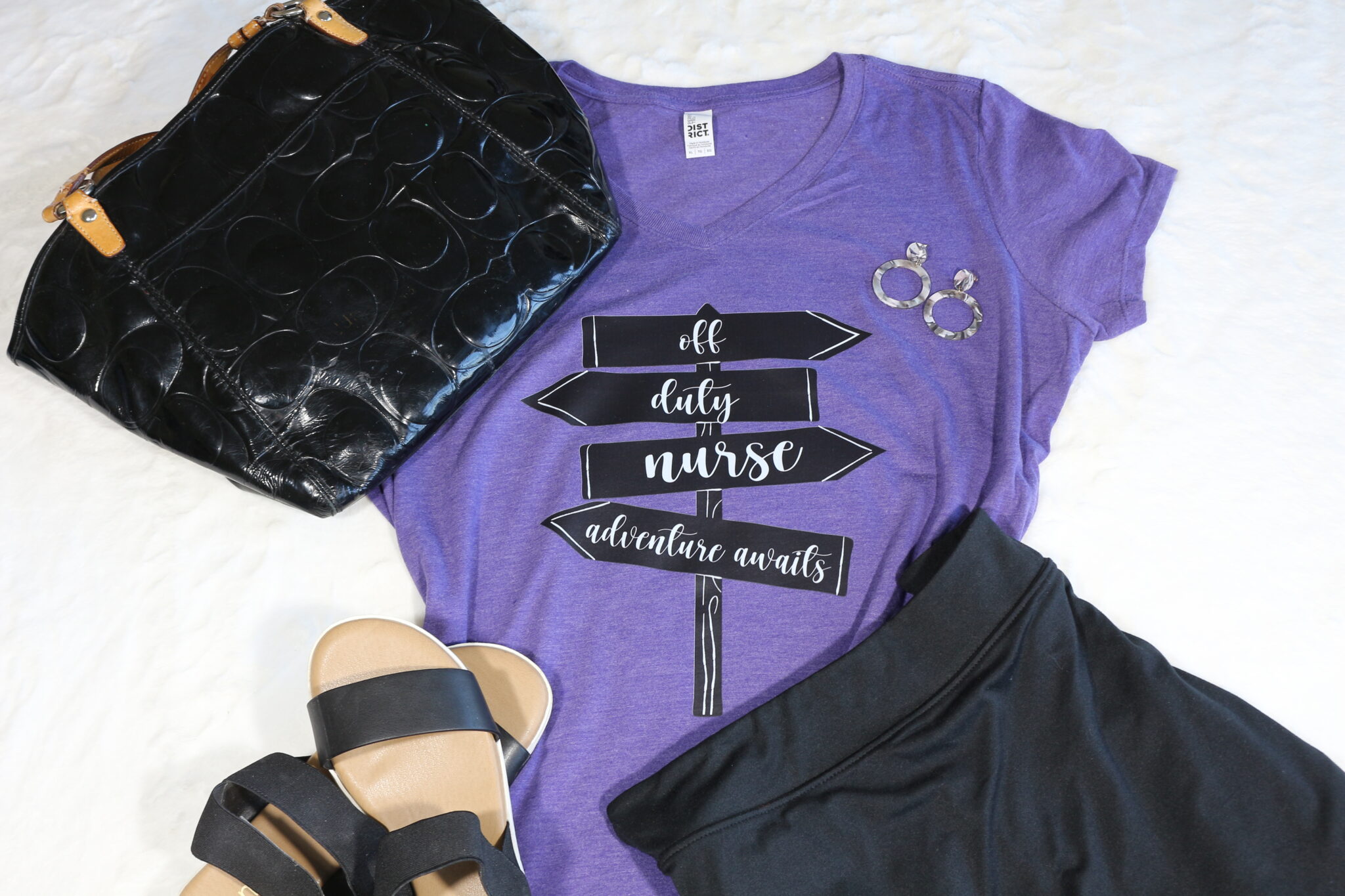Off duty nurse vneck purple tshirt with black tennis skirt, black sandals and black purse