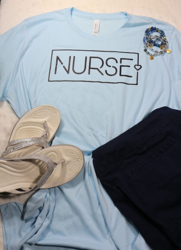 Light blue tshirt with Nurse and a heart on the logo, black skirt and silver flip flops