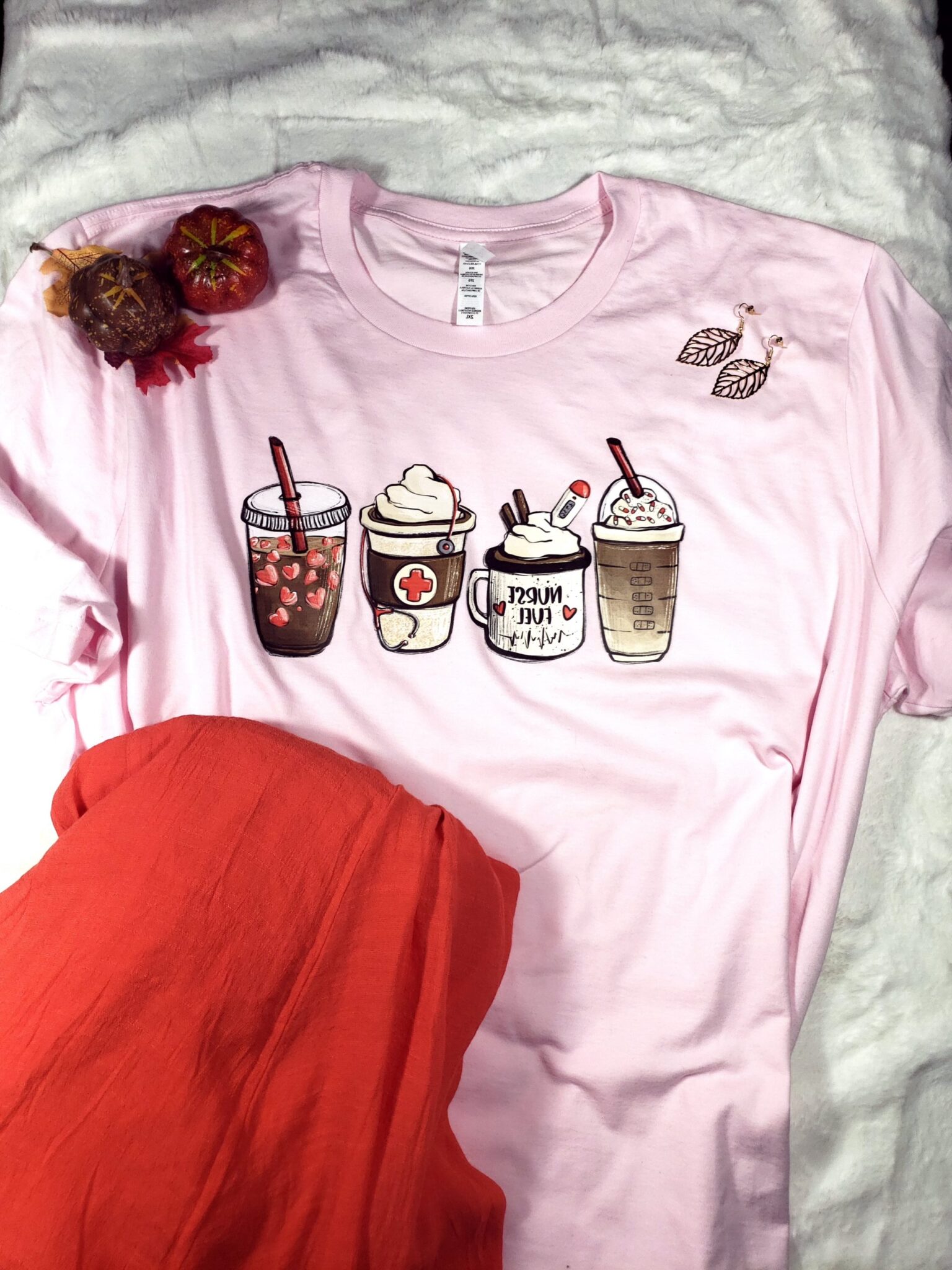 Pale pink tee with coffee cups, tangerine skirt, gold leaf earrings