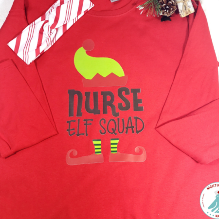 Long sleeved red shirt with graphic that says Nurse Elf Squad with elft hat and feet with red and white stripe headband