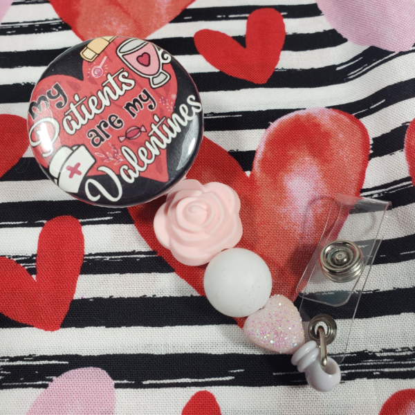 Valentine's Day beaded badge reel for nurses has a top that says My Patients are my Valentines with a rose bead and glitter pink heart bead