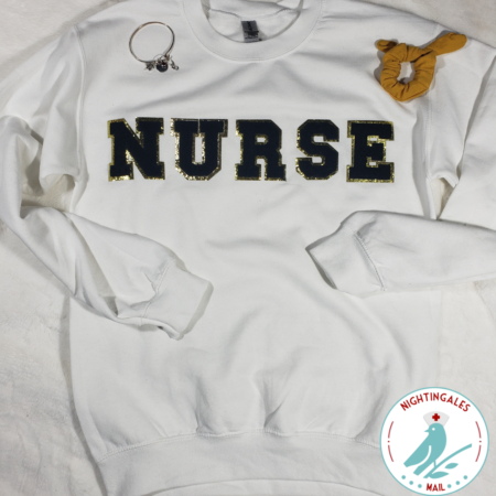 White nurse sweatshirt with black chenille letters that spell nurse