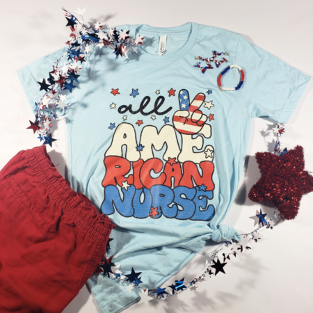 Light blue tshirt with All American Nurse printed on it, red shorts and 4th of July decorations